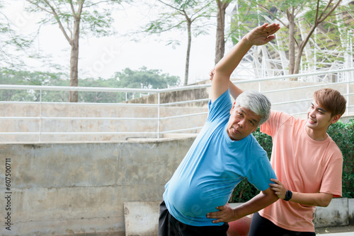 Asian family, Son helping elderly father which is obese in the belly to exercise starting from stretching the arm muscles. to elderly health care and exercise concept.