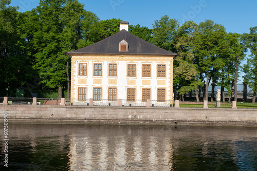 A two-story mansion in a summer garden on the banks of the river