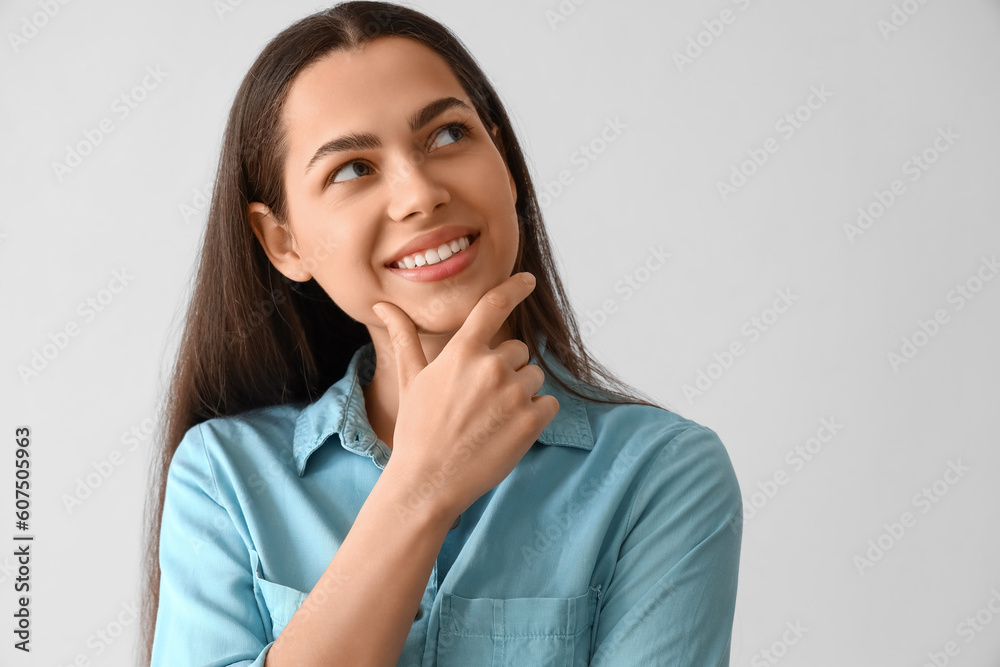 Thoughtful young woman on light background, closeup Thoughtful young woman on light background, closeup