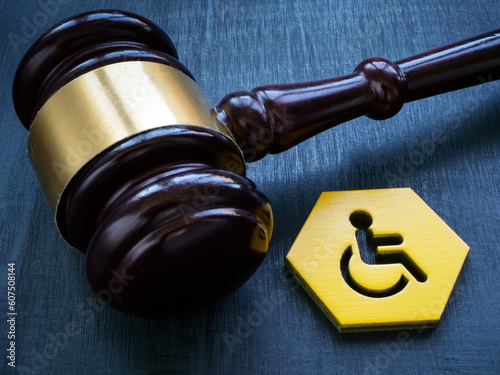 Gavel as symbol of law and disability person sign. photo