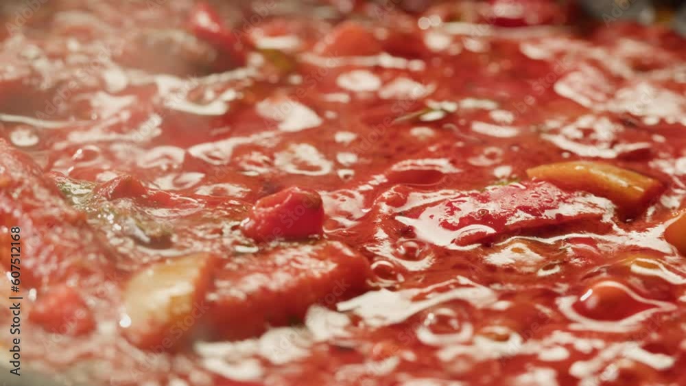 Cooking tomato sauce classic homemade Italian tomato sauce with basil for pasta and pizza in the pan. Chef cooking traditional Italian food. Cooking tomato sauce classic homemade Italian tomato sauce with basil for pasta and pizza in the pan. Chef cooking traditional Italian food.