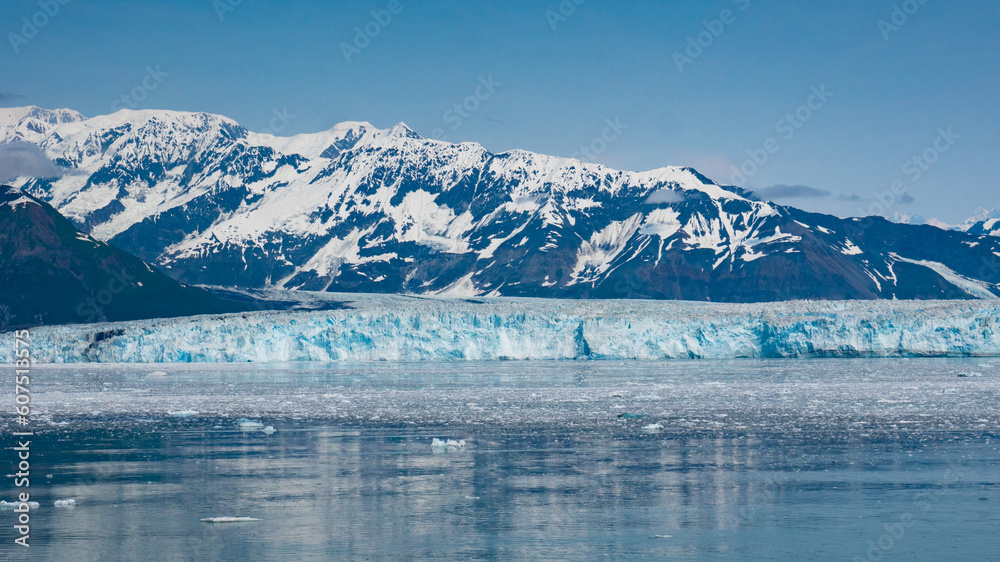 Alpine mountain glacier calving and ice in sea ocean water scenery nature.