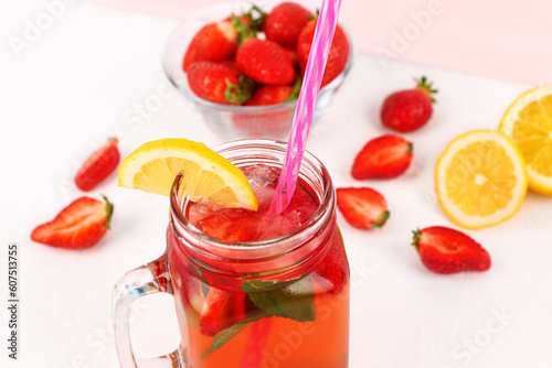 Mason jar of tasty strawberry drink on white background