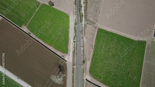 Aerial view of railroad crossing through a small towns with a storm coming in the background, Alboraia, Valencia, Spain. photo