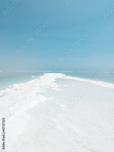 Landscape view on Dead Sea salt crystals formations, clear cyan green water at Ein Bokek beach, Israel