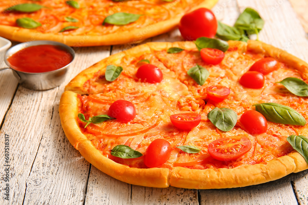 Tasty pizzas margarita on white wooden background Tasty pizzas margarita on white wooden background