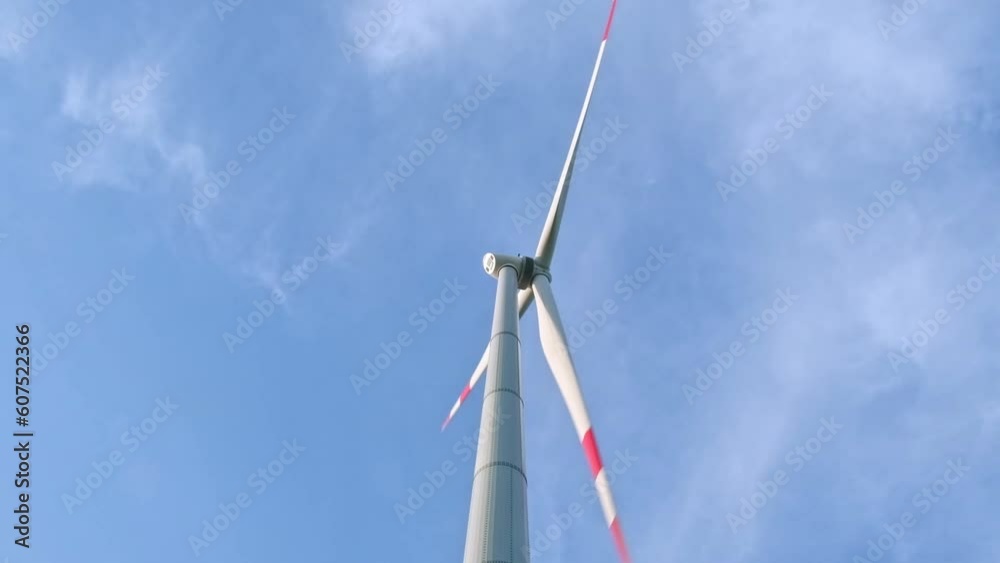 Wind turbines and agricultural fields on a summer day. Energy Production with clean and Renewable Energy Wind turbines and agricultural fields on a summer day. Energy Production with clean and Renewable Energy
