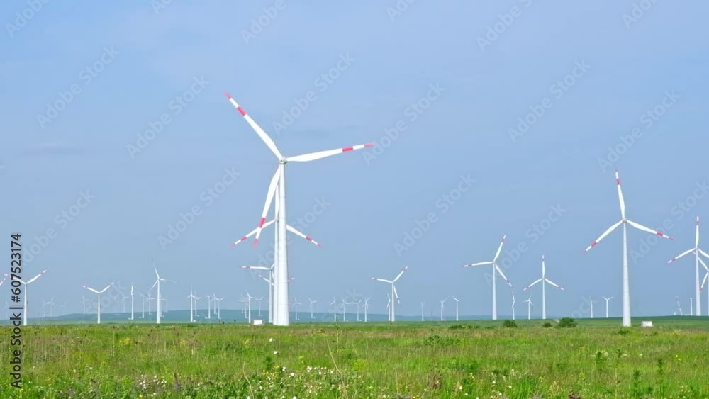 Wind turbines and agricultural fields on a summer day. Energy Production with clean and Renewable Energy