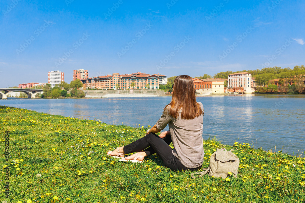 Tourist woman near Garonne river in Toulouse, France, South Europe