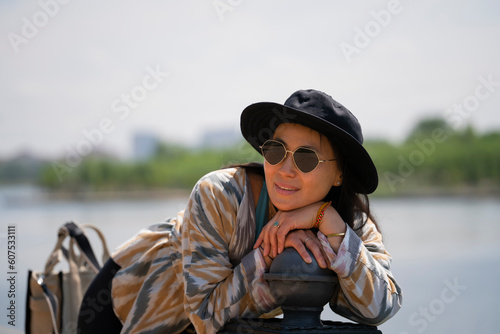 Portrait of a young Asian (Kazakh) woman in sunglasses and a hat. Portrait of a happy girl.