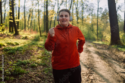 Fototapeta Naklejka Na Ścianę i Meble -  Calm, music and fitness person in nature for mental health, wellness and breathing, forest trees and fresh air. Mockup, sports and athlete woman thinking or listening to audio for running inspiration