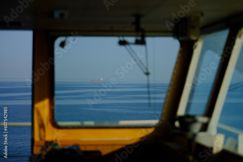 A view from the wheelhouse at sea during the sunrise.