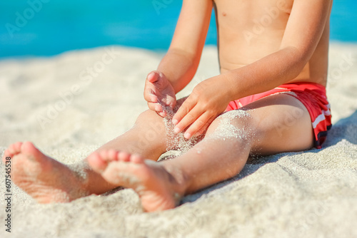 A feet of a happy child near the seashore in nature weekend travel