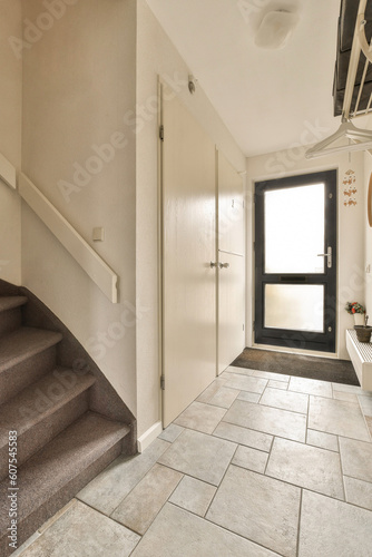 a hallway in a house with stairs leading up to the front door and an entryway on the right side