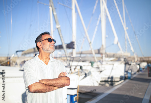 Relaxed Mature Man On Vacation Posing Near Yachts Outside