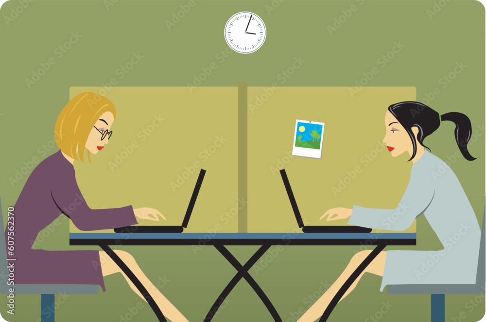 Two women in the office with laptops