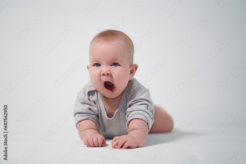 Yawning baby on a light background photo