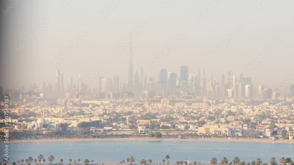 Panoramic tilt up window view to high buildings with balconies and marina in Sharjah district. Rented apartment stunning views and real estate business in united arab emirates Panoramic tilt up window view to high buildings with balconies and marina in Sharjah district. Rented apartment stunning views and real estate business in united arab emirates