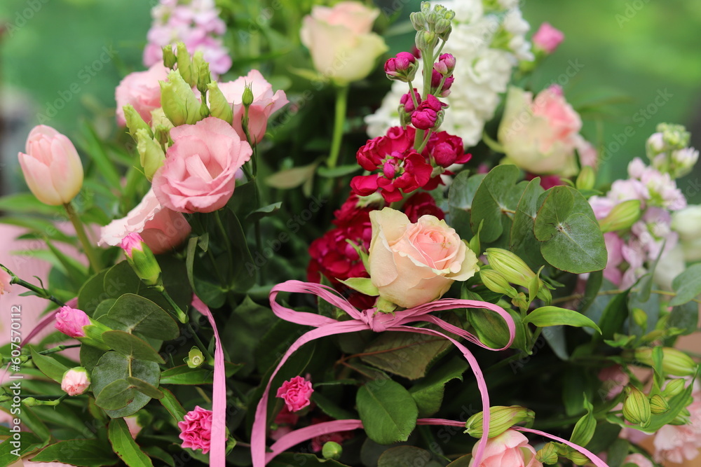 A bouquet of flowers with tea roses, carnations, dianthus caryophyllus, Delphinium, floristic composition.