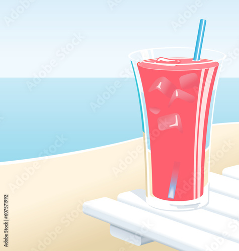 Cold glass of fruit punch or pink lemonade with ice, at the beach in the Summer.