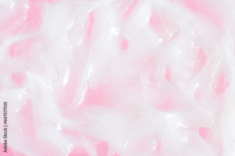 Smeared greasy melting cream. On a pink background.