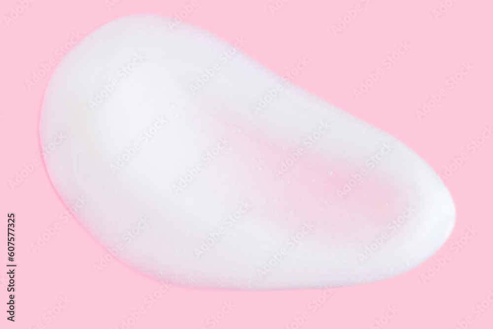 A smear of greasy. cream on a pink background. A smear of greasy. cream on a pink background.