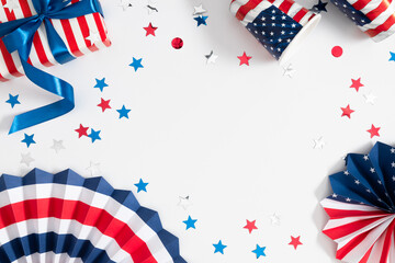 4th of July, USA Presidents Day, Independence Day. Paper fan, gift with  bow, confetti, paper cups on  white background, party, holiday celebration. Flat lay, top view, copy space, banner