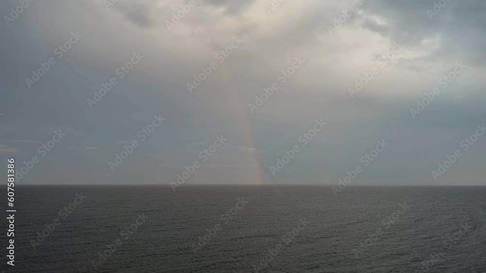Rainbow and rain in sea Rainbow and rain in sea