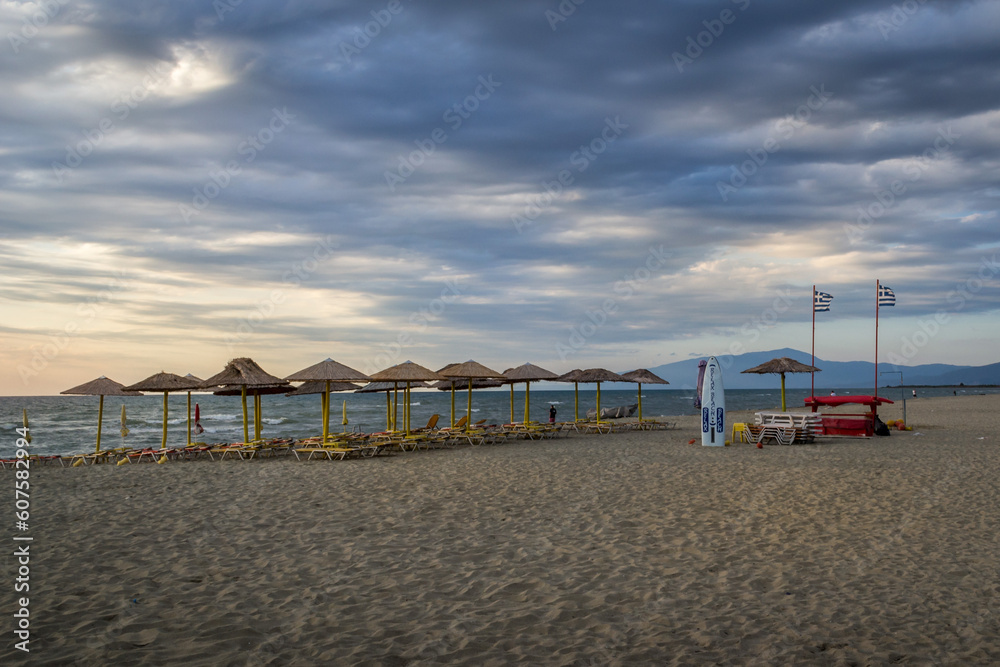 dramatic sky and the beach with umbrellas dramatic sky and the beach with umbrellas
