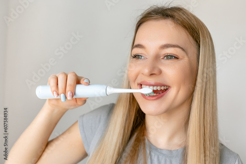Happy girl brushing beauty tooth using toothbrush . Copy space