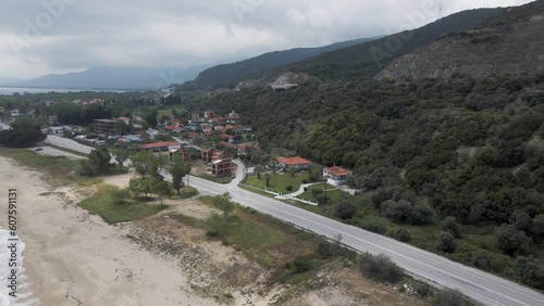 Aerial view of a road following a small empty beach along the Strymonian Gulf in the Aegean Sea, Nea Kerdylia, Central Macedonia, Greece. photo