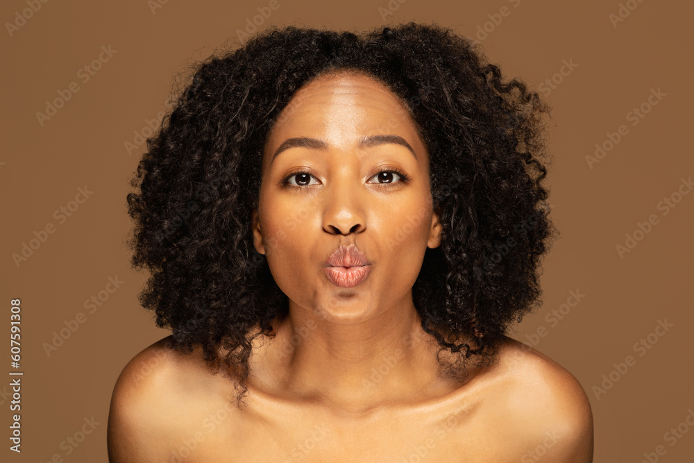 Closeup of playful topless young black woman showing kissing lips Closeup of playful topless young black woman showing kissing lips