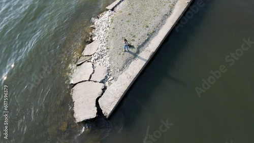 Aerial view of a woman taking photos along Volvi Lake coast in Mikri Volvi town, Central Macedonia, Greece. photo