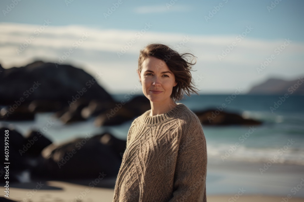 Portrait of a beautiful young woman on the beach at sunset.