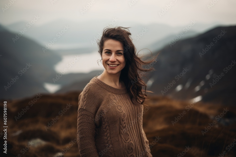 Portrait of a beautiful woman with long brown hair in the mountains Portrait of a beautiful woman with long brown hair in the mountains
