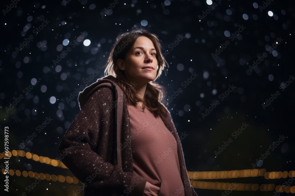 Young woman in winter clothes on a background of night city lights. Young woman in winter clothes on a background of night city lights.