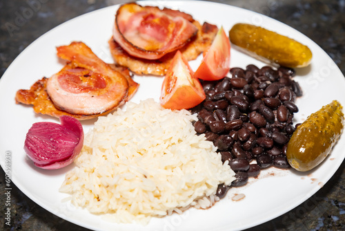 Traditional Brazilian daily meal, black beans, rice, meat, salad. real food