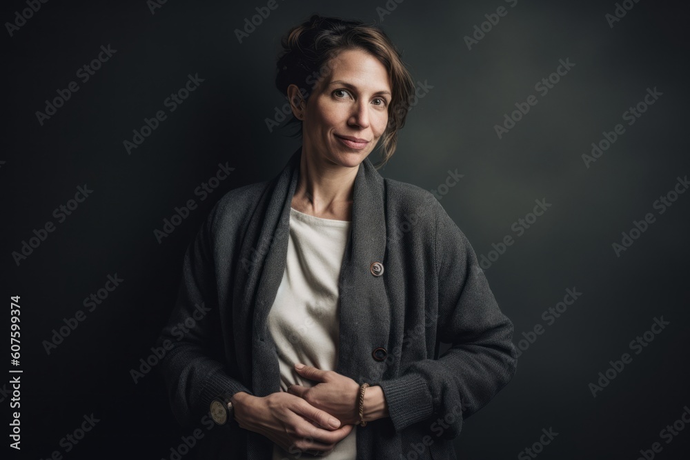 Portrait of a beautiful woman in a coat on a dark background