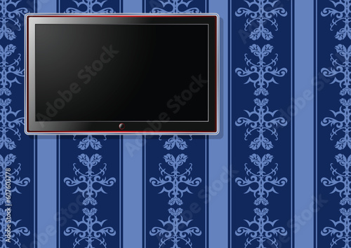 LCD television over bluish vintage pattern wallpaper