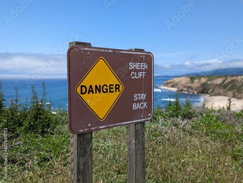 sign on the beach along Half Moon Bay, California coastline