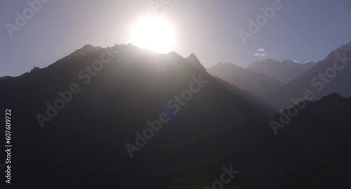 Aerial view of the sun setting in the back of high peak in Hunza Vallley located in the Karakoram range of the Himalayas, Gilgit Baltistan, Pakistan photo