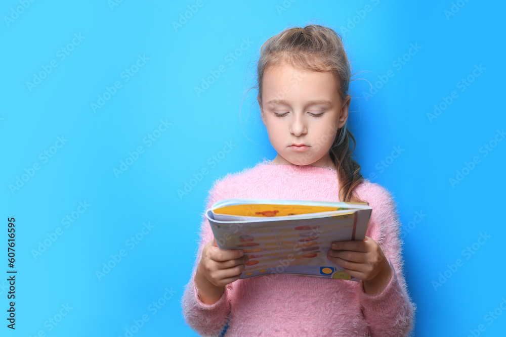 Little girl reading book on light blue background. Space for text Little girl reading book on light blue background. Space for text