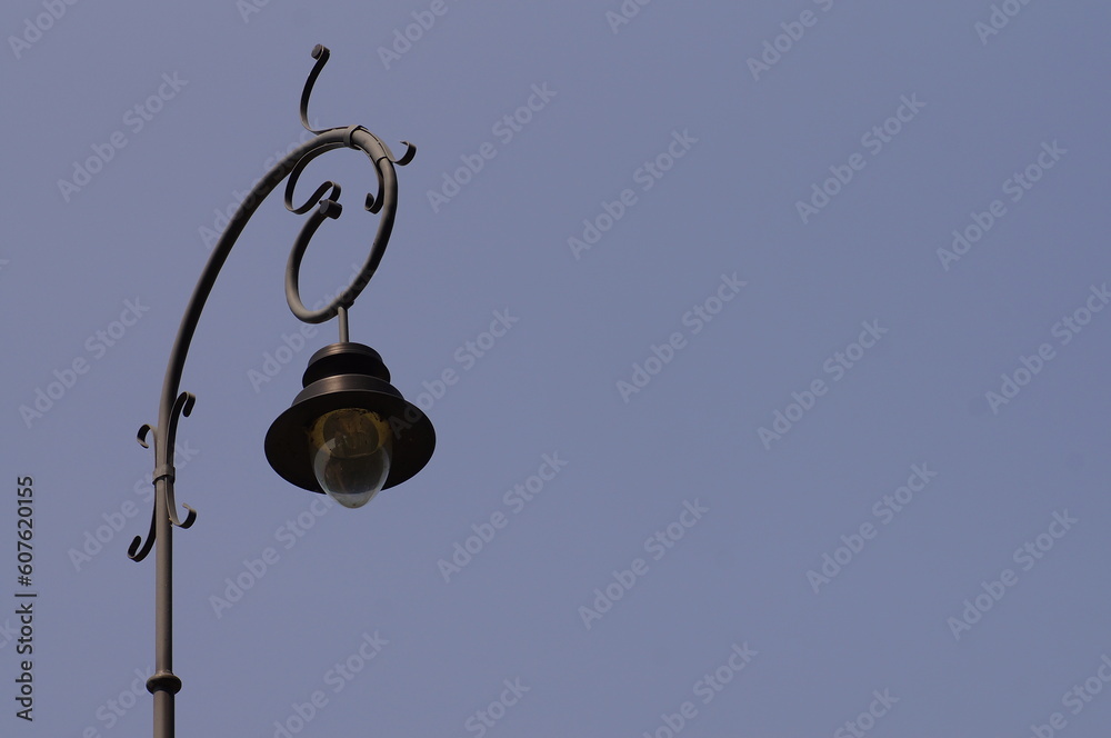 Street lamp against blue sky, photo with space for quote or title. - obrazy, fototapety, plakaty 