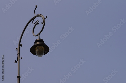 Street lamp against blue sky, photo with space for quote or title.
