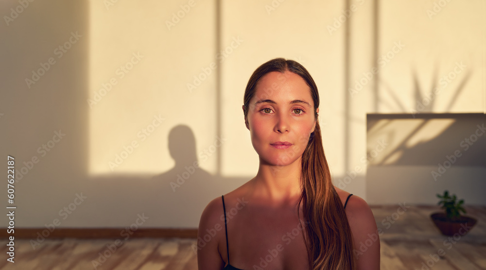 head shot portrait beautiful caucasian young adult woman sitting in yoga studio interior