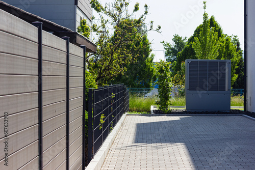 heat pump in a new building area with modern house facades