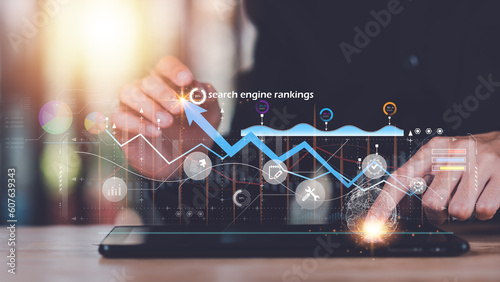Marketer showing SEO concept ,analysis of market data graphs and charts ,Optimization Analyzer ,website search engine ranking social media according to the results analysis data ,online marketing
