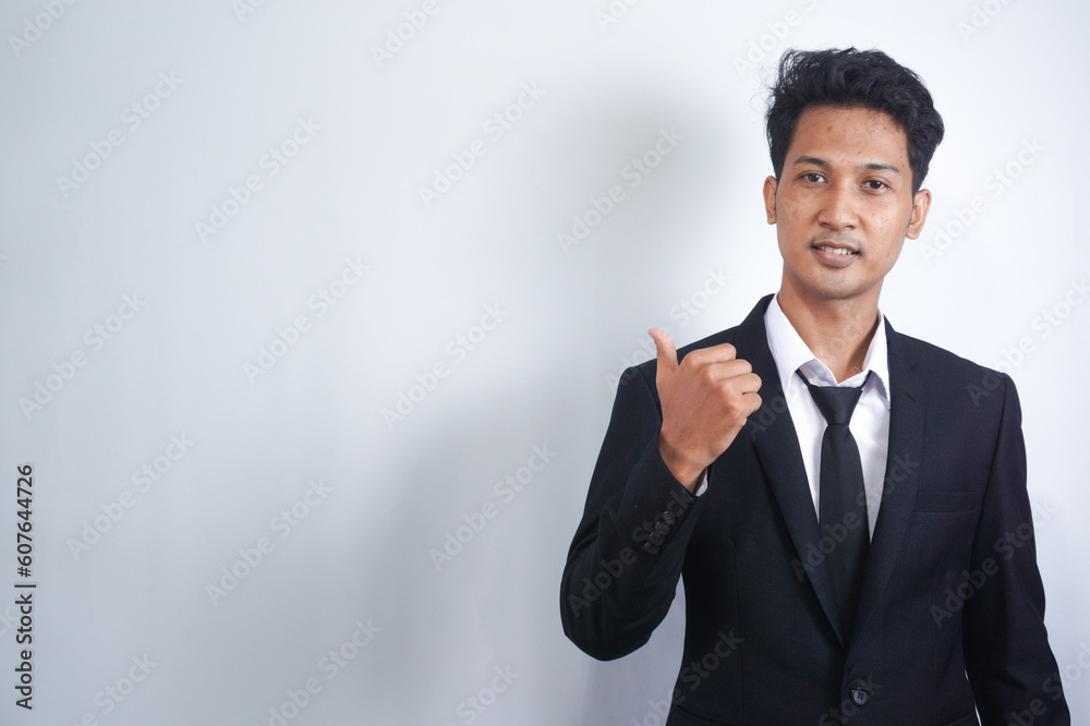 Young handsome Asian man wearing business clothes smiling and looking at the camera pointing with hands and fingers to the side. Young handsome Asian man wearing business clothes smiling and looking at the camera pointing with hands and fingers to the side.