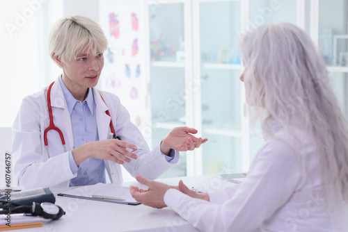 Therapist consults mature patient at appointment in hospital