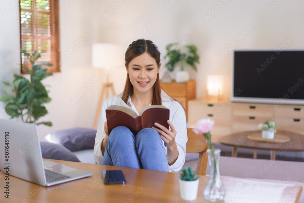 Working lifestyle at home concept, Women reading holy bible after working at modern home office Working lifestyle at home concept, Women reading holy bible after working at modern home office